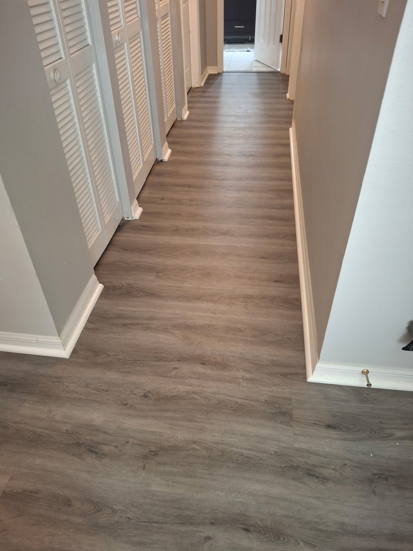 Finished plank flooring in a hallway
