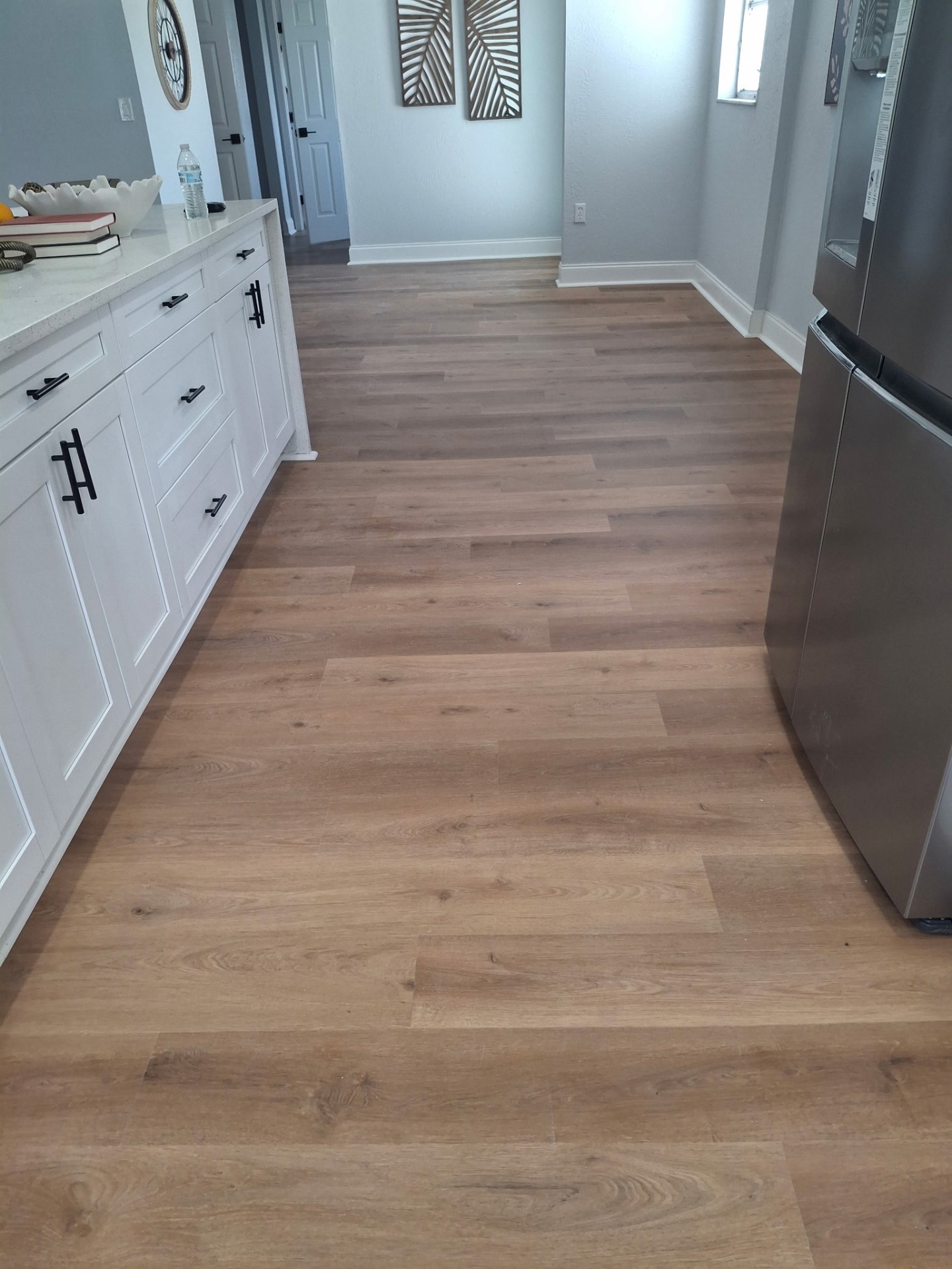 Finished plank flooring in a kitchen and dining space
